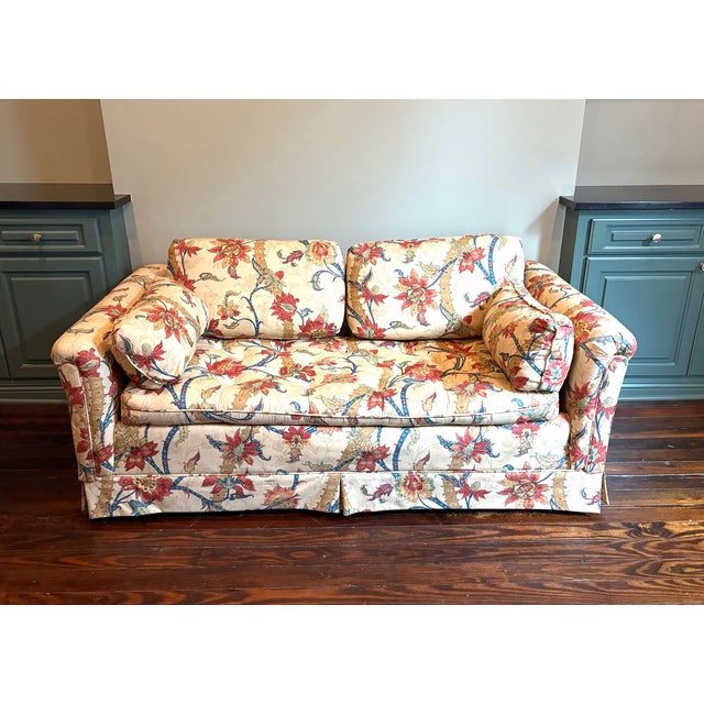 1970s rust/green/oatmeal floral loveseat w/ continuous tufted seat cushion. Excellent condition.