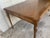 Early 20th large console table with a fold-open top, brass trim detail, and tapered fluted legs . The table has an easy...