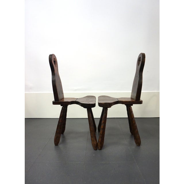 Pair of French Brutalist-style chairs. Robust design in solid wood with carved legs. Highly sculptural rustic chairs. They...