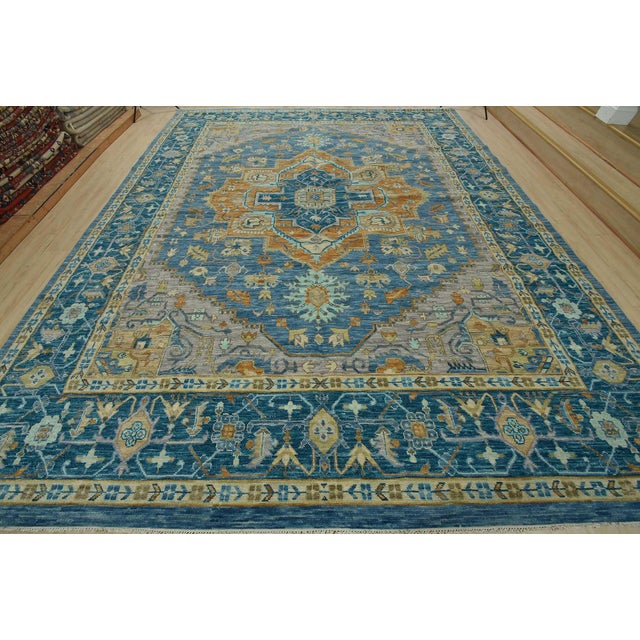 This traditional tribal Serapi rug is hand-knotted with an all-wool pile on a cotton foundation. This rug is new and in...