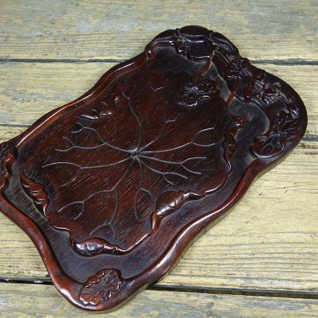 Elevate your coffee table styling with this exquisite Modern hand-carved wooden tray. Featuring a fluid, organic...