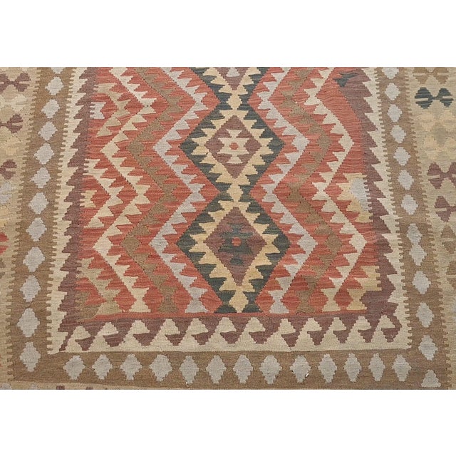 Mid 20th Century Vintage Handwoven Kilim Rug – 5’7” X 8’5” | Geometric Tribal Design | Earth-Tone Wool Flatweave For Sale - Image 5 of 5