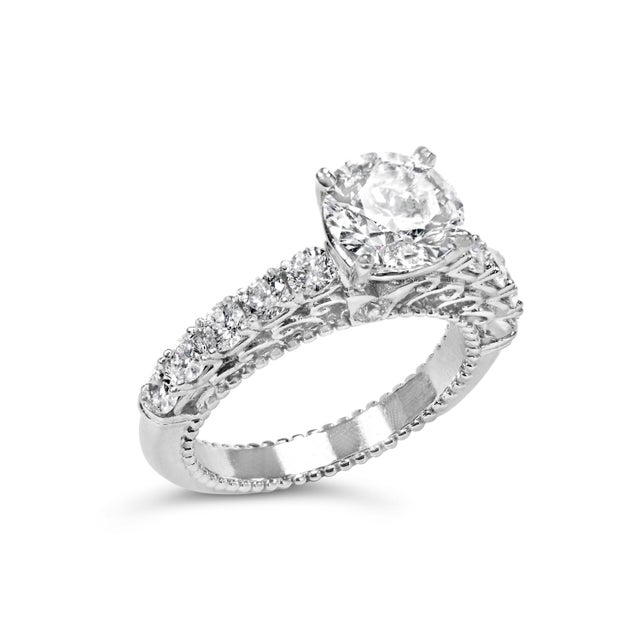 Immerse yourself in the timeless elegance of this 14K white gold engagement ring, where modern craftsmanship meets vintage...