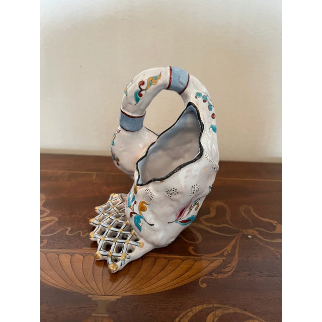 Very unique french faience object. Resembles a double basket with hand painted flowers and gilt edges.