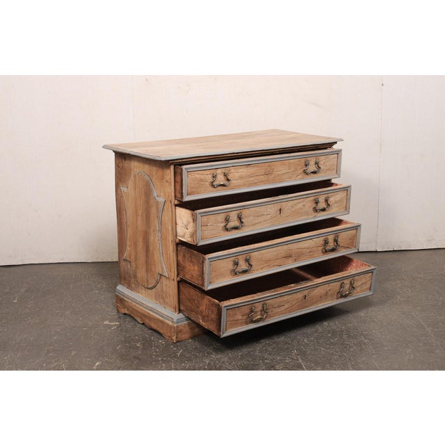 An Italian carved wood chest of four drawers from the 18th century. This antique chest from Italy has a rectangular-shaped...