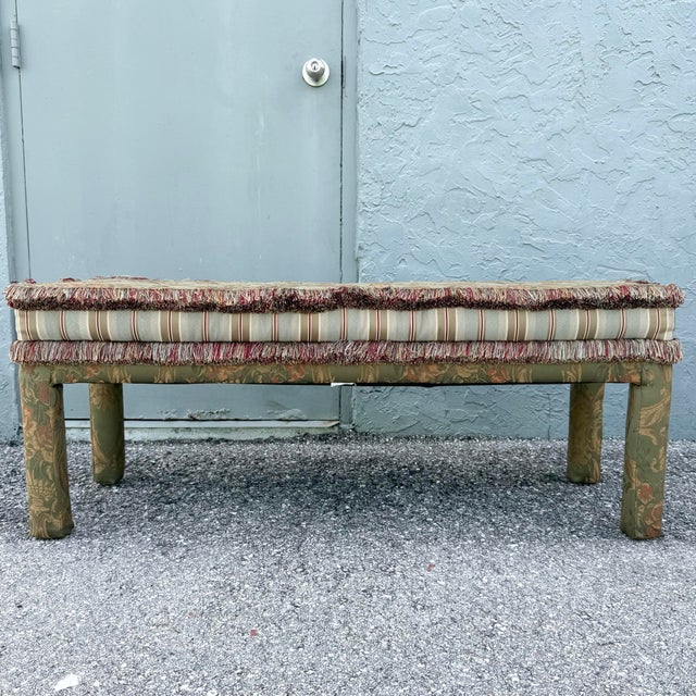 A glamorous vintage Hollywood Regency Parsons-style bench featuring richly layered upholstery in muted sage green, gold,...