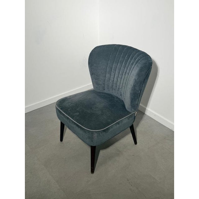 Elegant and compact cocktail chair by Dutchbone, featuring a beautifully curved shell back with decorative channel...