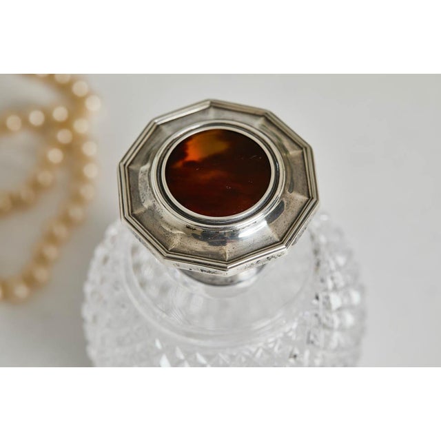 An elegant antique Mappin & Webb perfume bottle made of crystal, sterling silver and tortoise. The cut crystal is elegant...