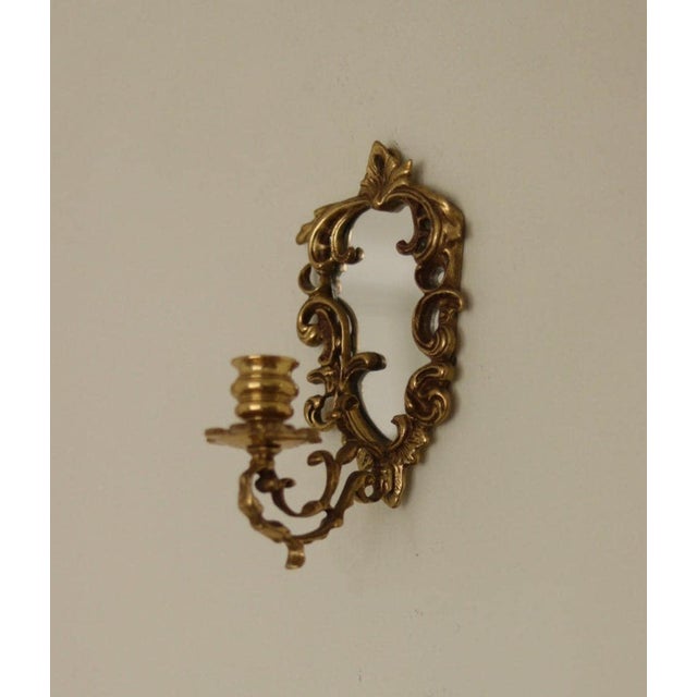 A striking pair of Mid-Century Swedish brass wall sconces with integrated mirrors. Crafted in Sweden, these elegant...