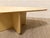 A beautifully sculptural coffee table with a bold postmodern silhouette and warm blonde wood finish. The asymmetrical top...