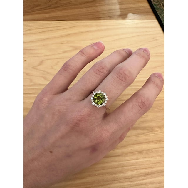 This beautiful ring features a 1.91 carat Peridot gemstone with natural earth mined diamonds in solid 14K yellow gold....