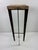 This is a late 20th century rustic industrial modern sculpture pedestal. This pedestal has a hand forged rustic iron base...