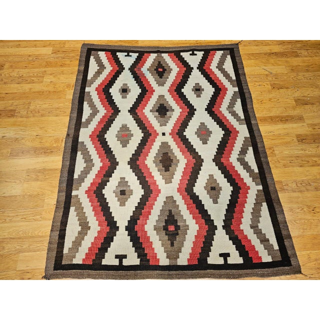 Presenting a striking piece of Native American hand crafted heritage with this large vintage Navajo rug, handwoven in the...