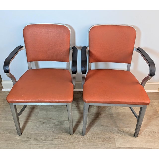 Bring a bold pop of retro industrial charm into your space with this striking matched pair of vintage Goodform armchairs....