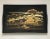 A mid 20th century handled serving tray showing a stylized landscape of river and mountains in a warm color palette with...