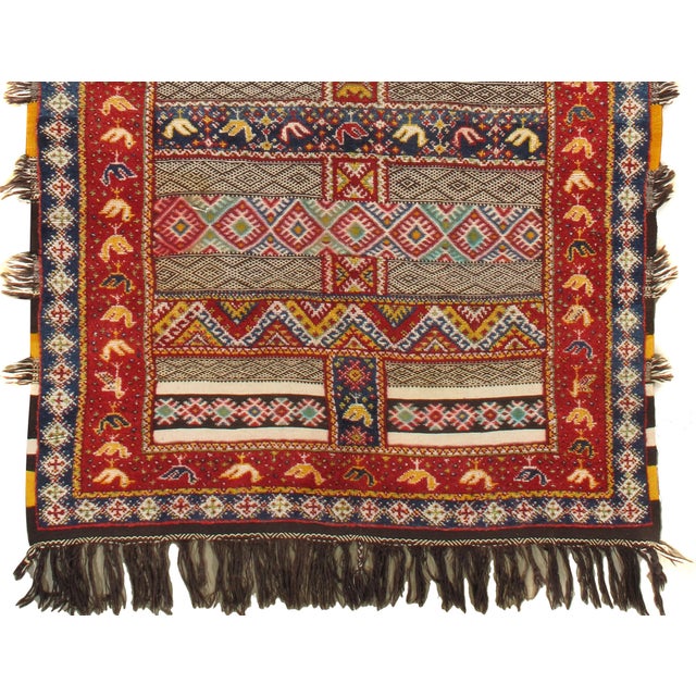 This vintage Moroccan hand-knotted wool rug features a low pile, giving it a refined and well-loved appearance. The...