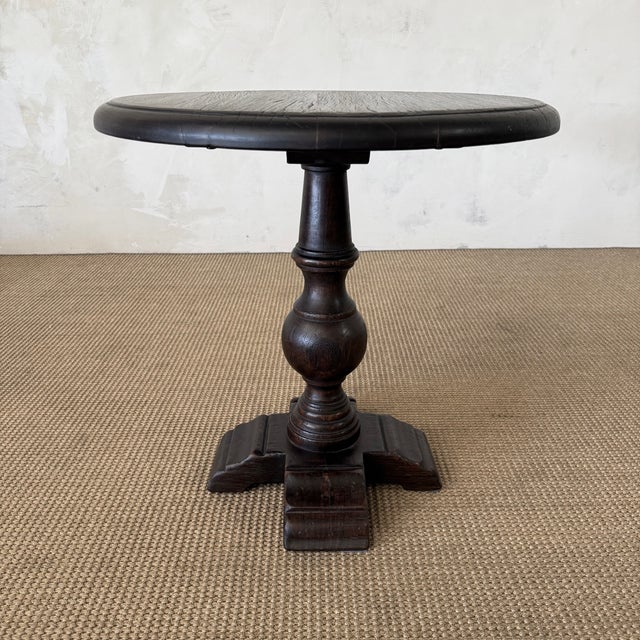 25.5"D x 26"H A round table with a flat top in a walnut finish. Made from reclaimed chestnut wood. The base features a...
