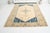 This is a vintage Turkish Oushak rug from the Mid 20th Century. The piece was hand-knotted.