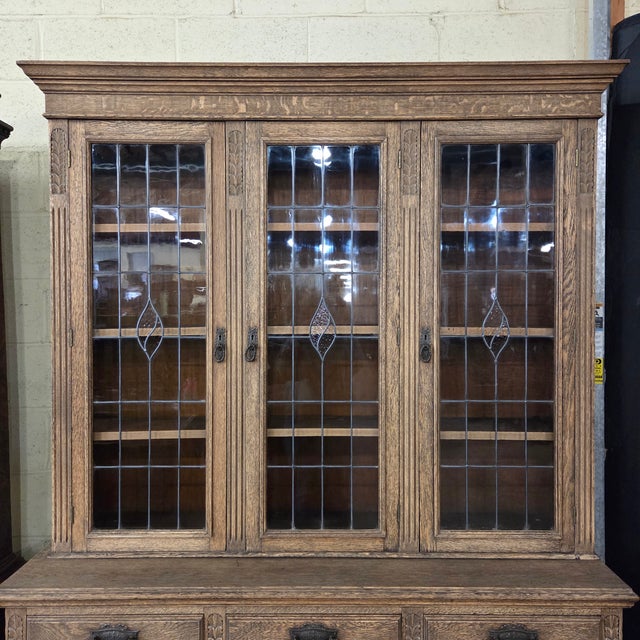 This English Late Light Oak 19th Century Carved Base and Glazed Top Bookcase is a beautiful piece with plenty of storage...