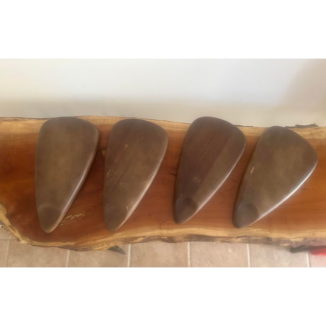 Stylish mid-century modern divided serving trays crafted from rich-toned wood, each featuring a built-in cork section for...