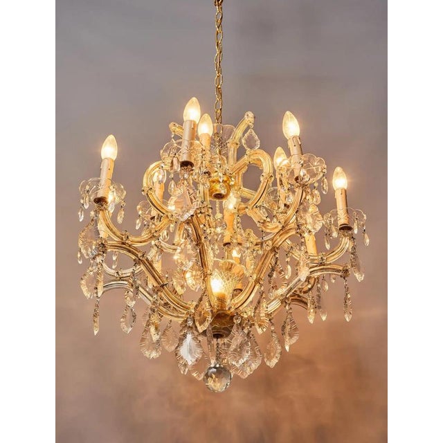 Two-story Theresian chandelier with crystal trimmings. Body made of polished brass. Trims are hand-cut and polished. Lower...