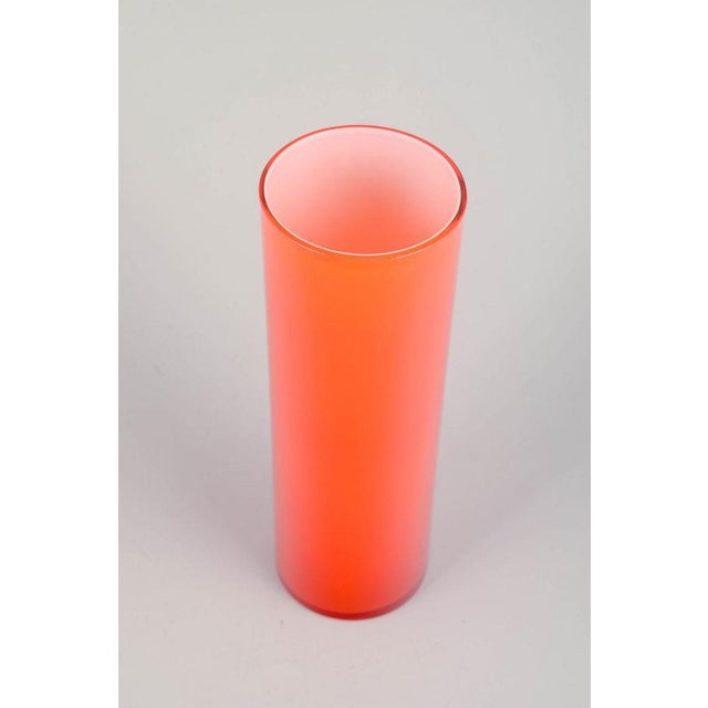 Swedish art glass Mouth-blown vase, 1970s. Elegant mouth-blown vase in bright orange glass with a tall, cylindrical shape....