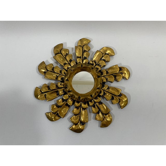 A splendid hand carved petite 10" diameter Florentine style Italian Giltwood Sunburst Wall Mirror, circa 1950s-70s. The...