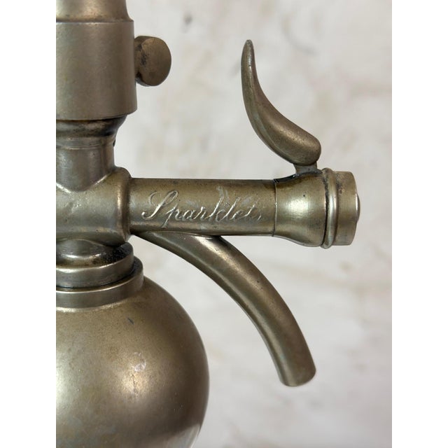 Elegant antique seltzer siphon from Sparklets, dating from the early 20th century. It consists of a thick glass bottle...