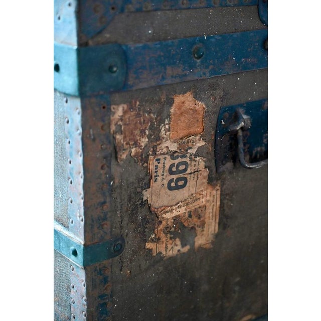 Made of wood covered with coated canvas, this antique trunk seems to have had a full life! We don't know much about it...