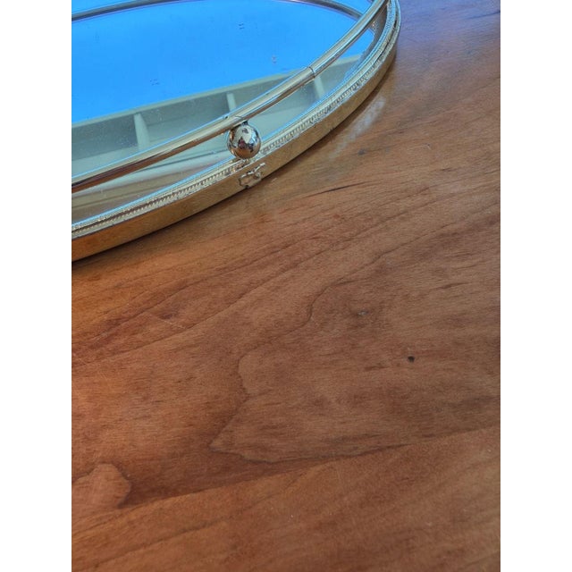 Vintage Mid-Century Hollywood Regency Oval Brass Mirrored Vanity Tray. This elegant vanity tray features a classic oval...