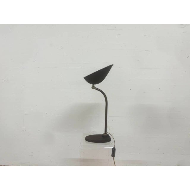 A characterful vintage desk lamp by bag turgi, dating from the 1940s. Its minimalist, functional design, featuring a...