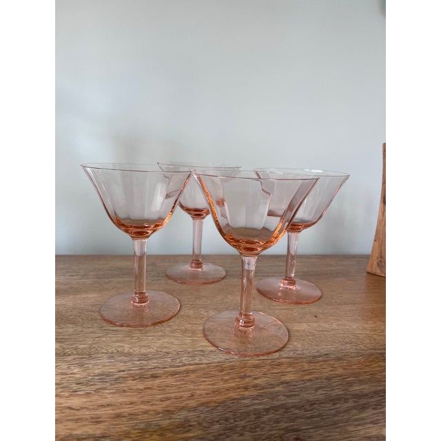 Enjoy some Champs or Cosmos with friends in these mid-century, peachy pink, Tiffin Franciscan faceted champagne glasses.