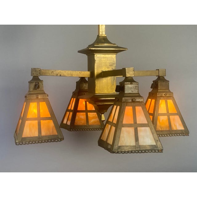 Offering an exceptional antique American Mission/Arts and Crafts chandelier dating to about 1910, and featuring a...