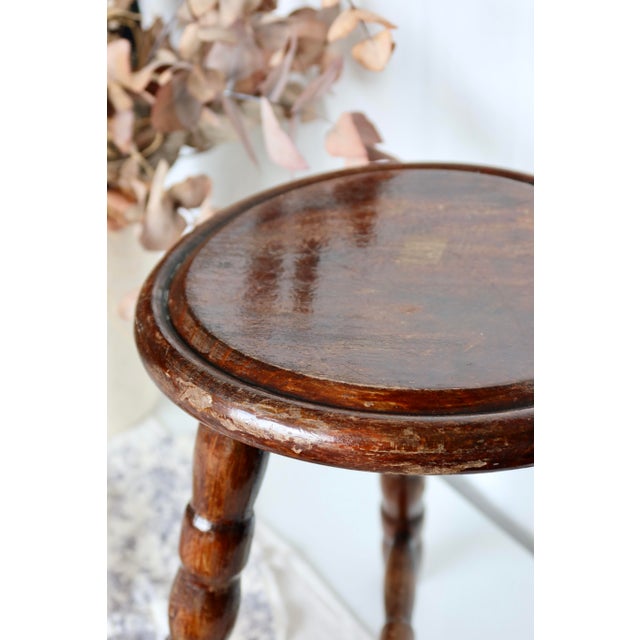 This vintage three-legged wooden milking stool is a fine example of functional period furniture. Designed to provide...