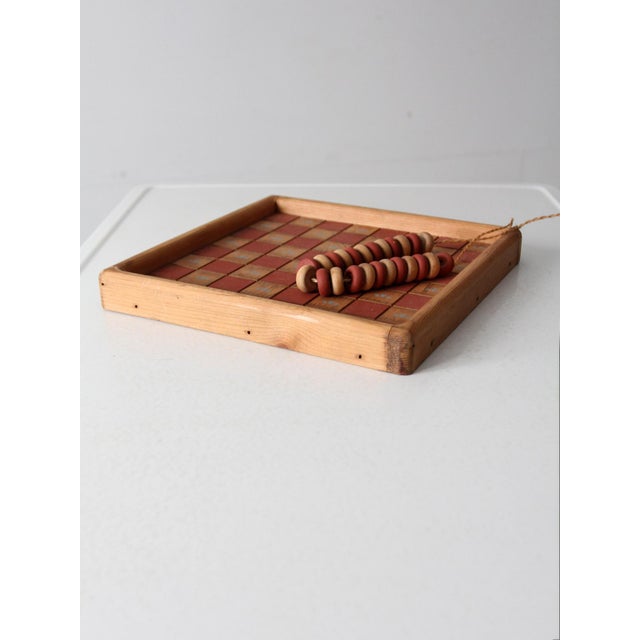 This vintage checkerboard features a barn red and natural wood design. Rustic country blue accents and handcrafted wooden...