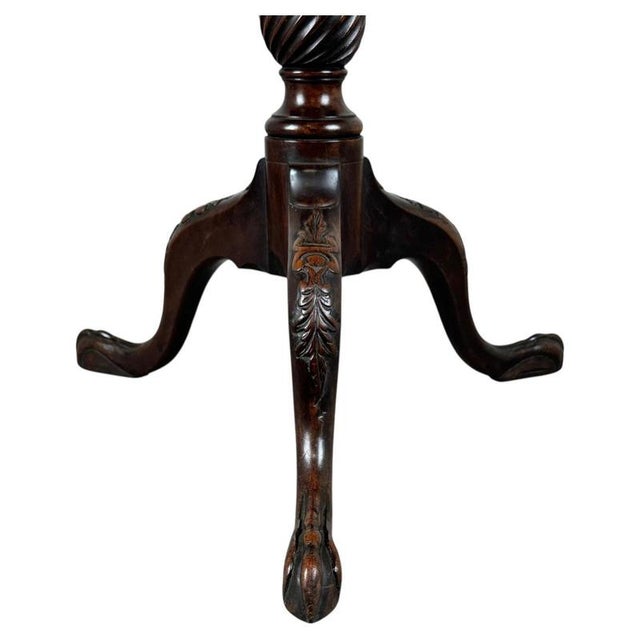 A fine 18th-century English tripod table, beautifully crafted from mahogany and displaying the elegant proportions and...