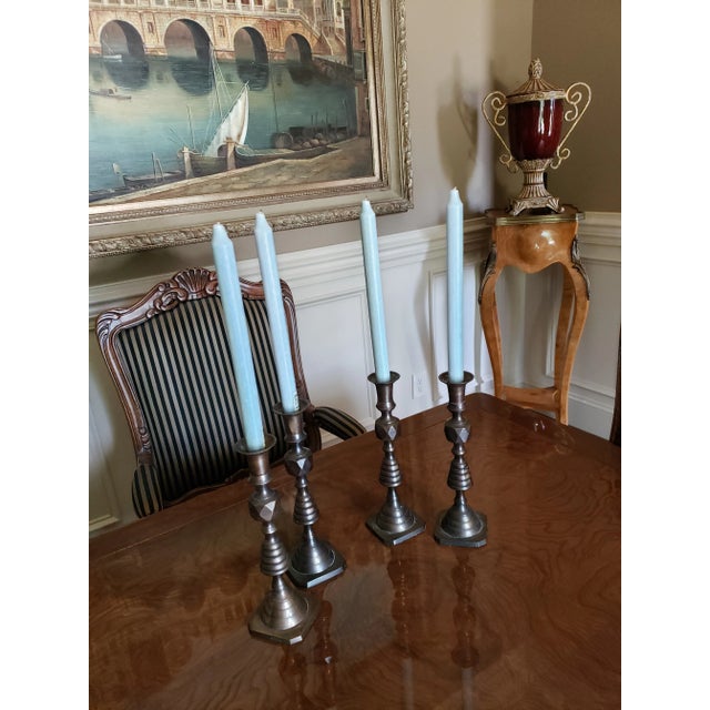 2 Pair's of bronze-colored candlesticks. Can be used together or separated. Bought them at a boutique shop in South...