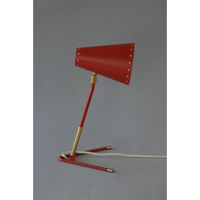 Wall / Table lamp by Borens Boras, Sweden. A conical lampshade is made of aluminium, lacquered in a red paint on the...
