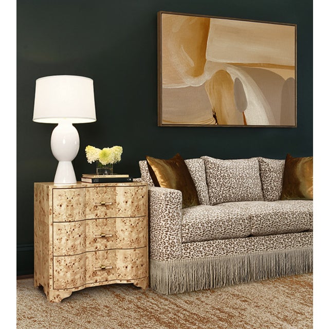 The Worlds Away Calvin Side Table features three drawers and intriguing acrylic hardware. With distinctive curves and...