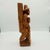 A wonderfully sculptural vintage hand-carved wood figure depicting a traveling peddler or village merchant carrying his...