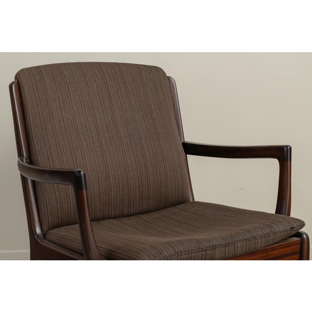 Armchair with arms made of teak wood structure with upholstered seat and backrest. Designed in the 1960s by Ole Wanscher...