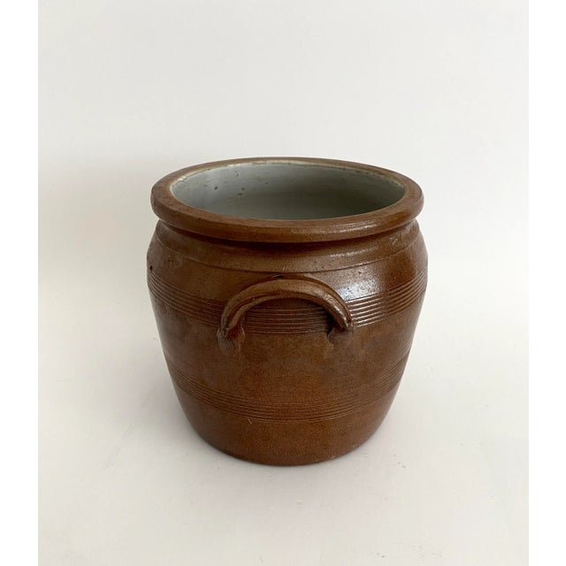 1940s French stoneware confit pot with traditional lambs ear handles and salt glaze finish was manufactured by the...