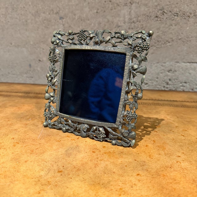 For your consideration, a picture frame with intricate floral and vine design, this vintage-style picture frame is likely...