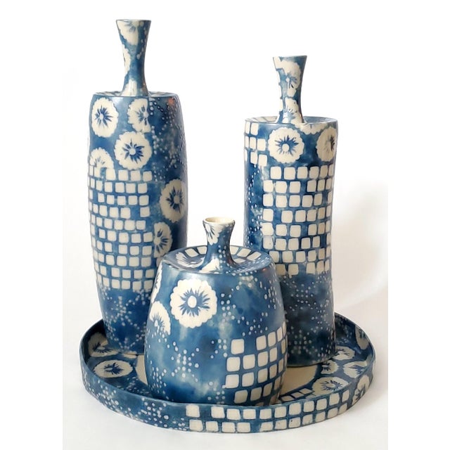 Offering a set of vintage modern trio of porcelain vases with original porcelain tray by renowned designer Jamie Young....