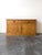 This antique English pine sideboard features a warm, rich honey-toned finish. Designed with two smooth sliding top drawers...