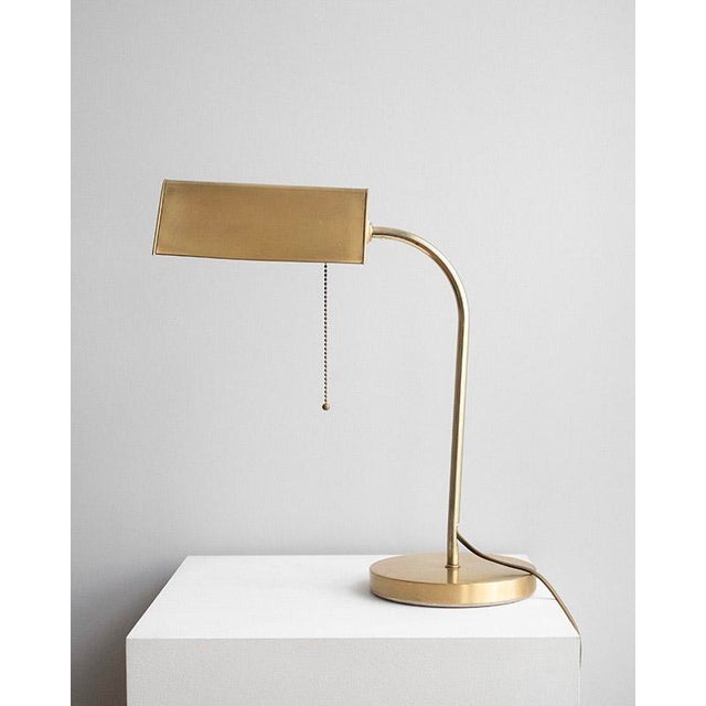 Elegant banker table lamp from the 1970s by the German manufacturer Karstadt AG. The lamp is made of brass with a...