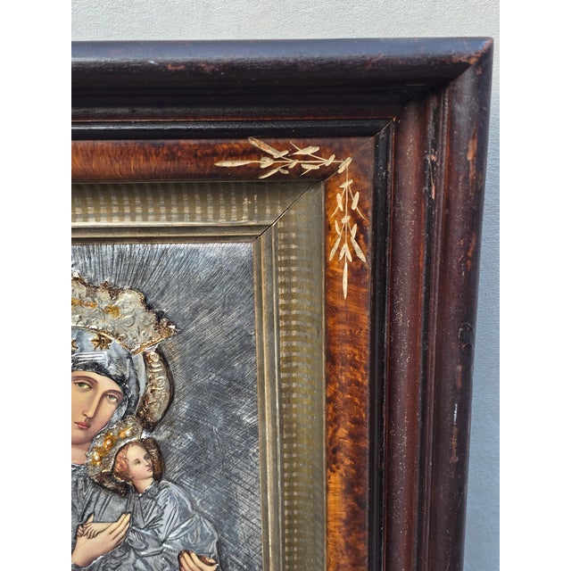 This is an antique Italian Orthodox icon featuring the Virgin Mary and the Child Jesus. This icon features a silver metal...