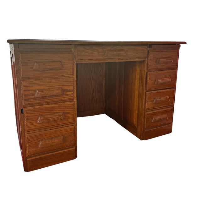 A substantial vintage double-pedestal executive desk crafted in warm-toned oak and oak veneer. Its compact 48-inch width...