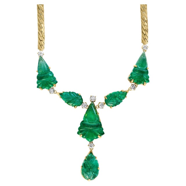 This stunning necklace features a remarkable combination of natural carved drop emeralds weighing 115 carats and 4 carats...