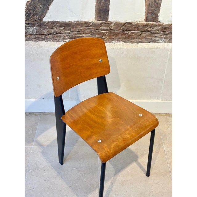 A rare and iconic mid-century French "Metropole 305 / Standard Chair," designed by Jean Prouvé, in black lacquered metal...